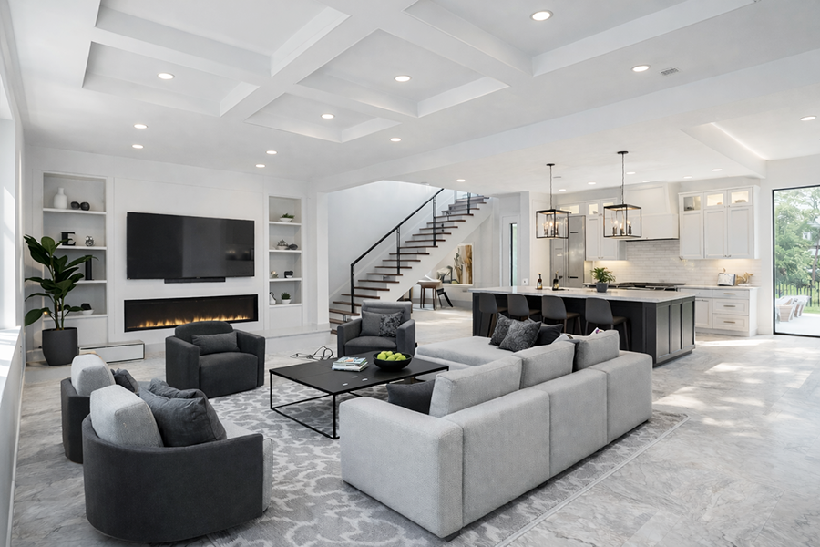 Full-home remodeling project in Tampa Bay featuring open-concept living area, custom kitchen, and modern staircase by Ambry Design