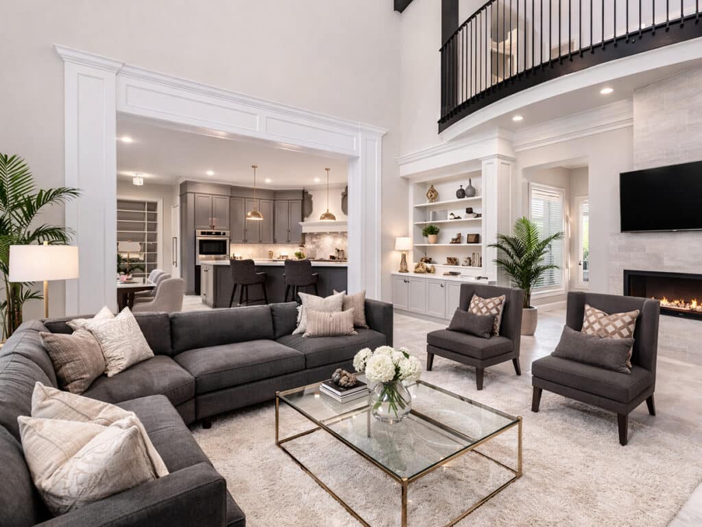 Full-home remodeling project in Tampa Bay featuring open living room, fireplace wall, integrated kitchen, and loft-style upper level